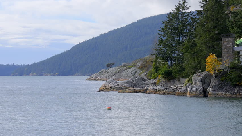 Establishing shot. Luxury house with nice Fall ocean view and rocky landscape in Vancouver, Canada, North America. Day time on October 2023. ProRes 422 HQ.
