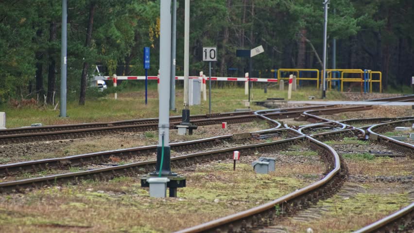 Railroad Track Junction and Road Crossing with Signal Semaphore with Blue Light Designating Railway Train Maneuver Area