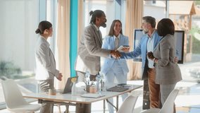Group of multiracial business people colleagues or employees shaking hands before starting meeting indoors at  table in conference room upon arrival - Powered by Shutterstock - Get 15% off with code: PIKWIZARD15