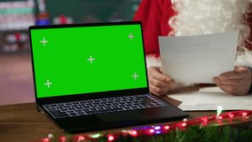 Saint Nicholas checking his correspondence next to isolated copy space at the North Pole, reading letters from children before Christmas eve. Old man Santa enjoying the winter holiday. Camera A. - Powered by Shutterstock - Get 15% off with code: PIKWIZARD15