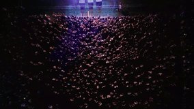 Amazing overhead shot of a crowd of people attending a concert or festival. Crowd of people at a concert in the evening, Aerial view of a huge concert crowd having fun with popular electronic music - Powered by Shutterstock - Get 15% off with code: PIKWIZARD15