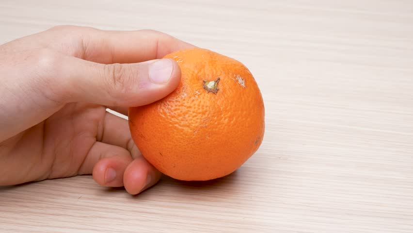 Peeling tangerines on table, 4K video, with sound.