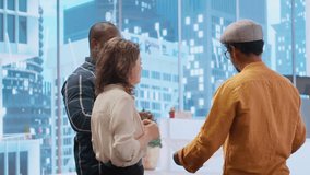 Corporate team reviewing architectural plans for a new office, discussing the building layout and the blueprints, potential investment opportunity in real estate during an office tour. Camera B. - Powered by Shutterstock - Get 15% off with code: PIKWIZARD15