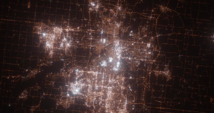 Des Moines (Iowa, USA) aerial view at night. Top view on modern city with street lights. Camera is zooming out, rotating clockwise. Vertical video. The north is on the left side