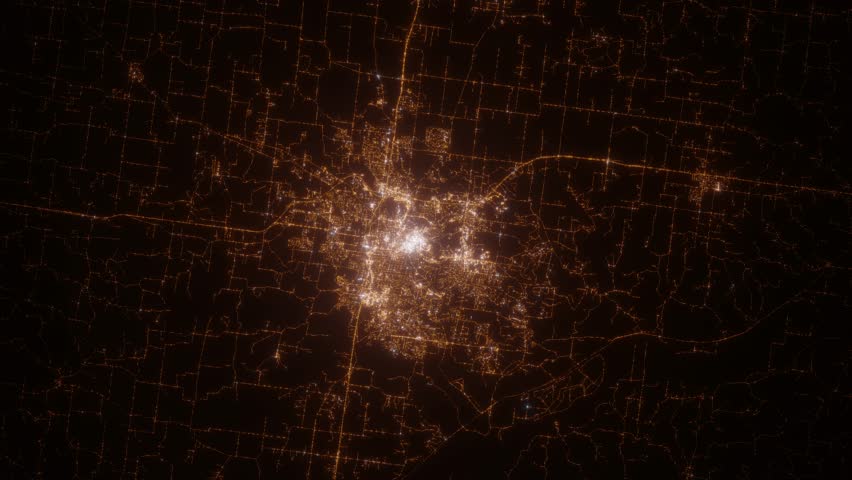 Columbia (Missouri, USA) top view at night. Top view on modern city with street lights and glow effect. Camera is zooming in, rotating clockwise. Vertical video. The north is on the left side