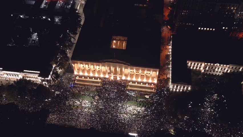 Tbilisi, Georgia - 28th october, 2024: aerial top view georgian people in street by parliament in anti-government post elections protests in capital Tbilisi. Rustaveli avenue. Pro european protests