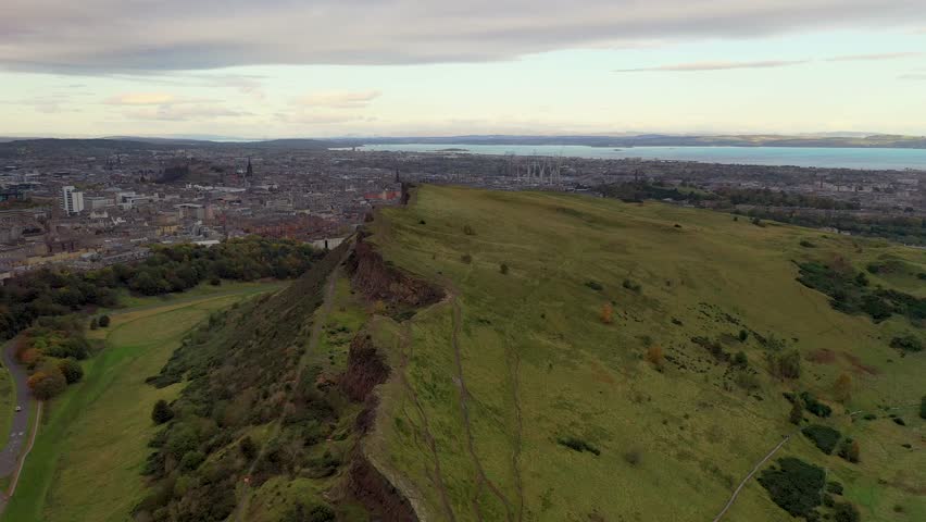 Aerial view of arthur seat overlooking the cityscape and skyline, edinburgh, scotland.