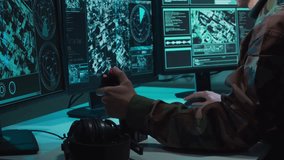 Military soldier operating advanced technology in a command center. - Powered by Shutterstock - Get 15% off with code: PIKWIZARD15