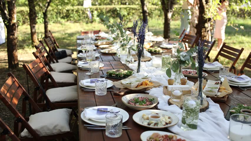 beautiful wedding table with food and drinks for an outdoor banquet in the park