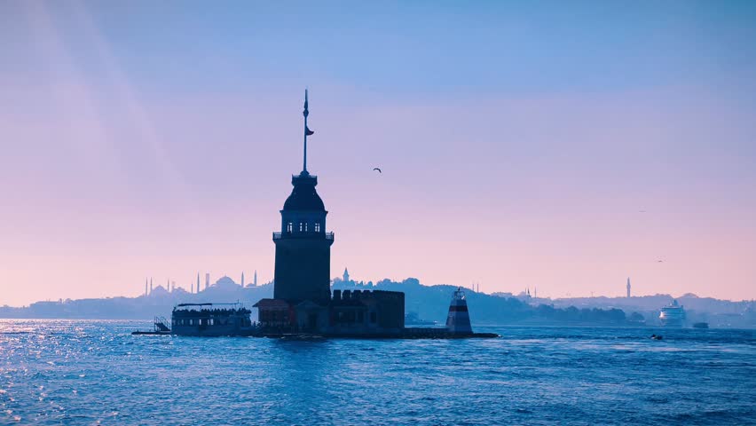Maiden's Tower at sunset in Istanbul, Turkey. The Maiden's Tower stands silhouetted against a soft, pastel sunset sky in Istanbul, Turkey. 4k fullhd video symbol of Istanbul 