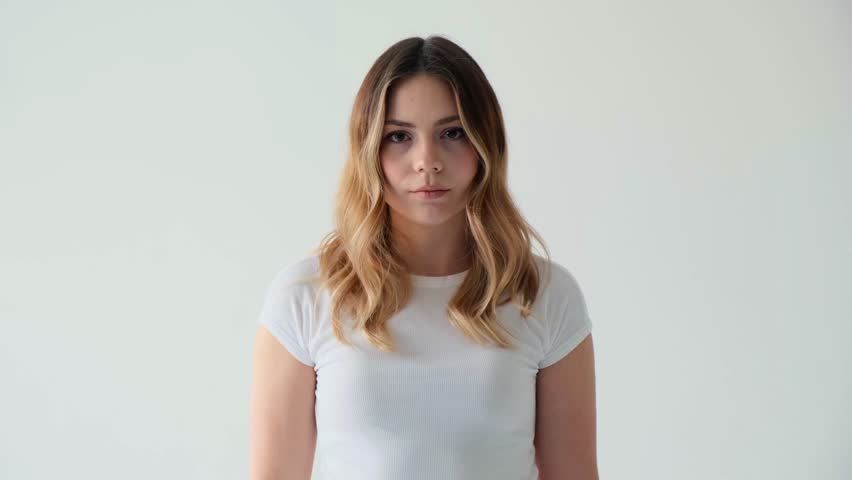 Portrait Of A Caucasian Woman Waving Finger In Denial On White Background