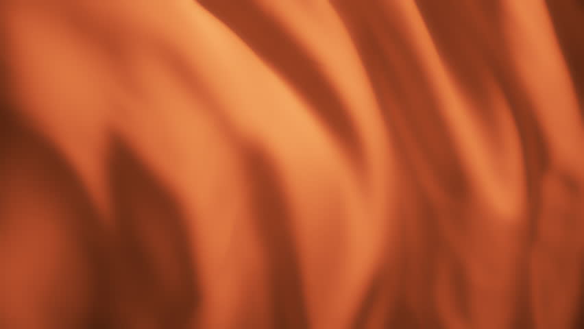 Wavy orange chiffon fabric flowing in the wind. Abstract texture background. Slow motion. 