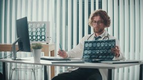 A Doctor Works in a Modern Office, Analyzing Digital Medical Data and X-rays on His Computer to Provide Accurate Diagnoses. Digital Data in Healthcare, Precision and Modern Diagnostic Techniques. - Powered by Shutterstock - Get 15% off with code: PIKWIZARD15