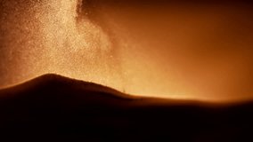 Particles falling on the sand pile in slow motion. Abstract macro shot.  - Powered by Shutterstock - Get 15% off with code: PIKWIZARD15