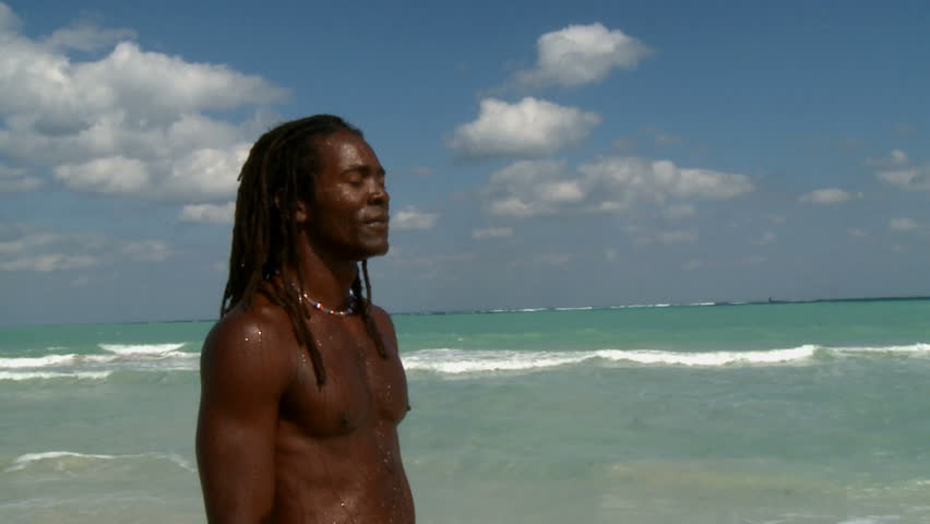 Man relaxing and walking on a beach in Cuba