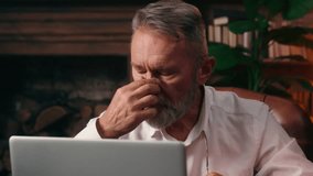 Tired exhausted elderly Caucasian man businessman rub eyes headache overworked laptop computer health work unhealthy fatigue business frustrated vision old male office unwell temples indoor glasses - Powered by Shutterstock - Get 15% off with code: PIKWIZARD15