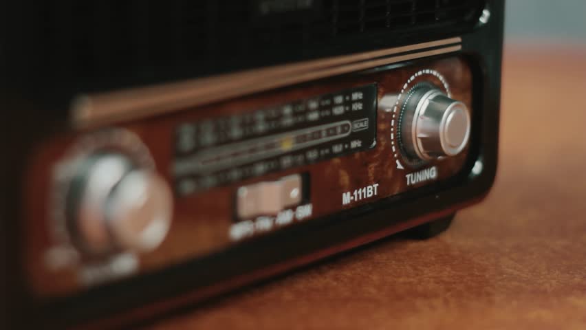 Old-fashioned radio close-up. Male hand searching channel