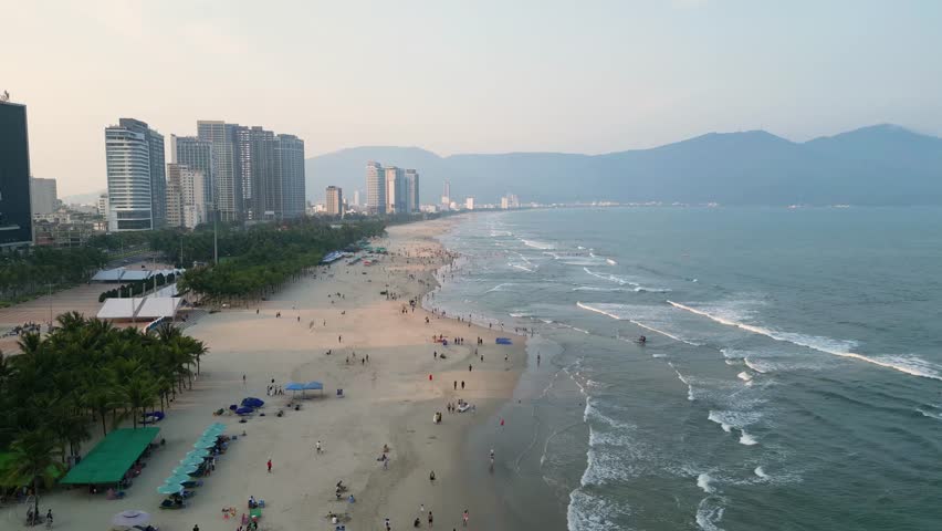 Beachfront Hotels And Crowded People At Da Nang In Vietnam. Aerial Drone Shot