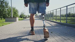 On a bright and sunny day, a man confidently walks along a park path, showcasing his prosthetic leg. He enjoys his surroundings, embodying determination and resilience. - Powered by Shutterstock - Get 15% off with code: PIKWIZARD15