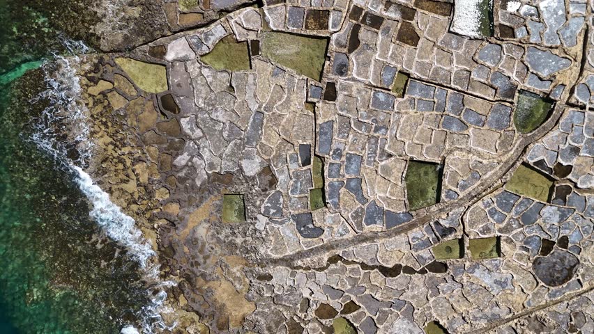 Drone view of Xwejni Salt Pans in Gozo Island, Malta
