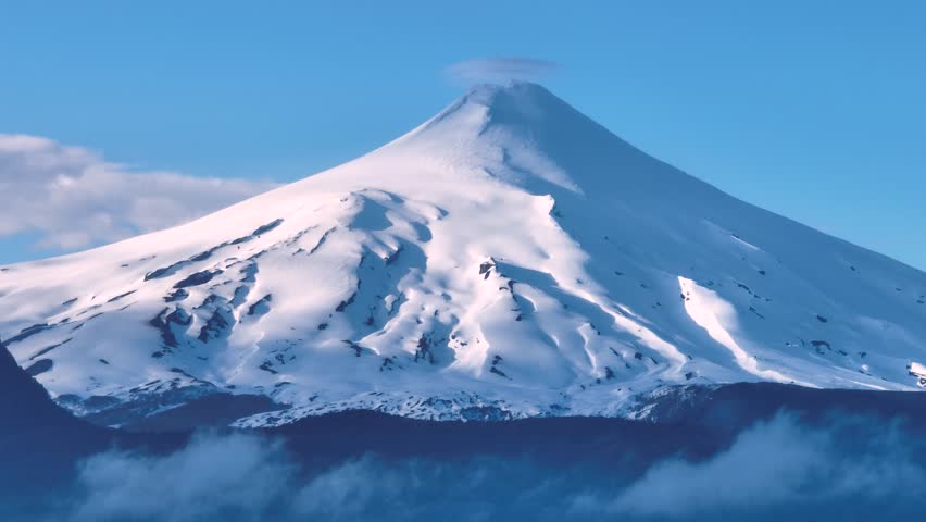 Majestic scene showing Villarrica volcano rising through the clouds. Araucania, Chile