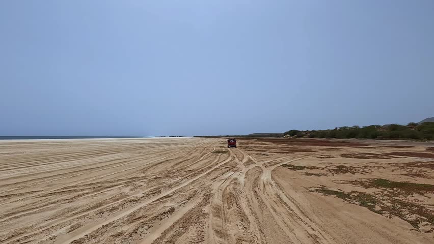 Driving along Santa Monica beach on Boa Vista island, Cabo Verde. Car pov