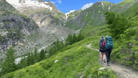 a pair of people hiking in the ALPS mountains - following the TMB (Tour du Mont Blanc) trail - Powered by Shutterstock - Get 15% off with code: PIKWIZARD15
