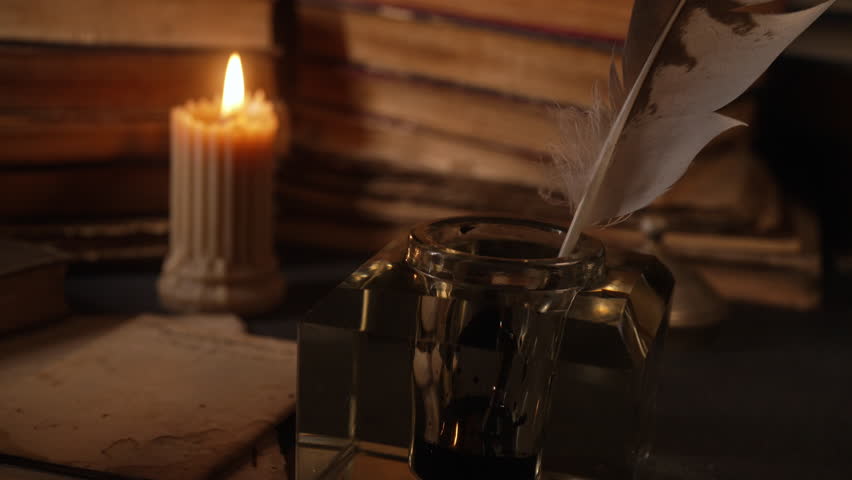 Man Takes Feather Quill Pen From Inkwell. Warm Glow Light Of Old Candle. Books.