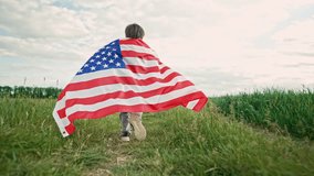 Cute little boy - American patriot kid running with national flag on open area countryside road.USA, 4th of July - Independence day, celebration. US banner, memorial Veterans, election - Powered by Shutterstock - Get 15% off with code: PIKWIZARD15