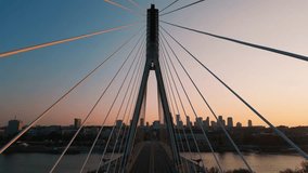 modern metal cable bridge over Vistula river at sunset, contemporary geometric architecture, cable-stayed bridge at city skyline, symmetry and architectural urban contrast, Warsaw 4k - Powered by Shutterstock - Get 15% off with code: PIKWIZARD15