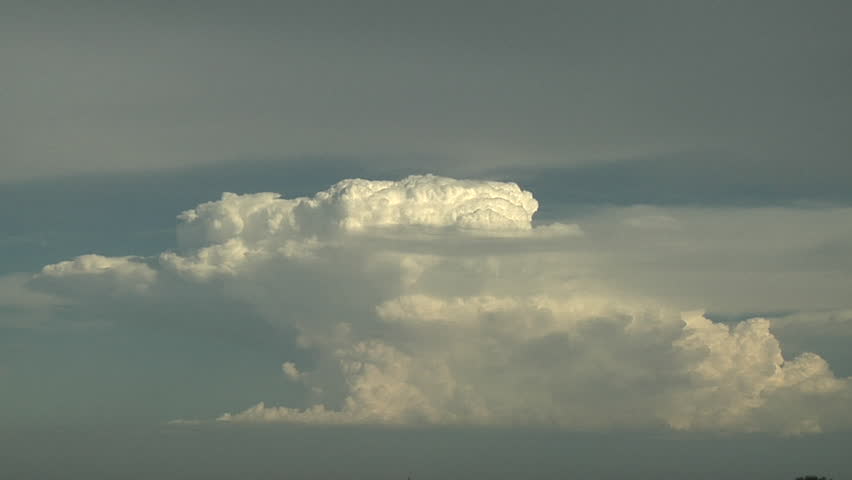 Storms Intensifying. Strong updrafts can be seen feeding a distant, developing thunderstorm complex