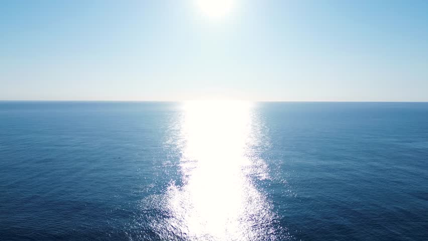 Drone aerial landscape of sun rays early morning reflection on ocean sea coastline horizon with humpback whale in water Sydney Australia travel tourism nature