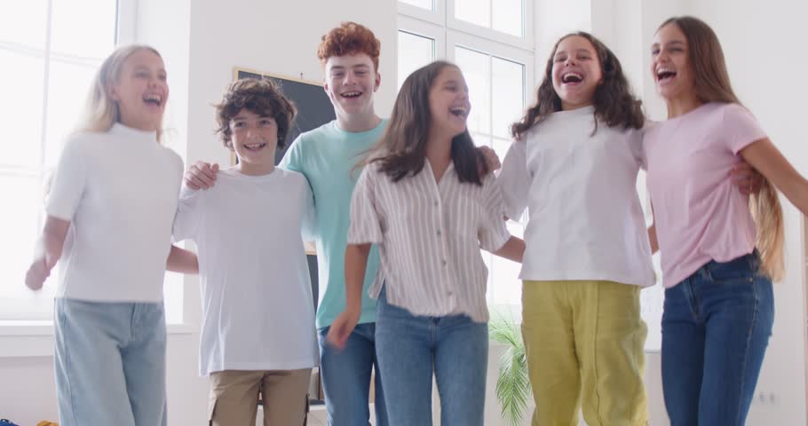 Happy teen friends group jump, young fellow people laugh having fun posing, diverse students reunion fun, school club team community mates meeting, teenagers together enjoy common friendship joy 