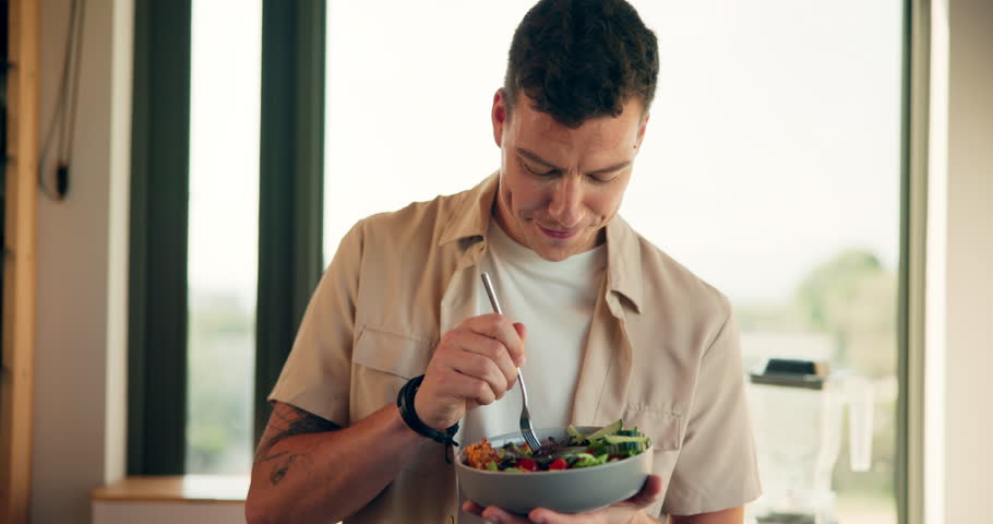 Man, eating or salad in kitchen for diet, healthy food or satisfied with fresh vegetables. Nutritionist, lunch meal or smile in home for gut health, digestion aid or fiber for lose weight or nutrient