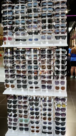 Sunglasses Shop. Display cabinet in store selling eyeglasses. Vertical format video