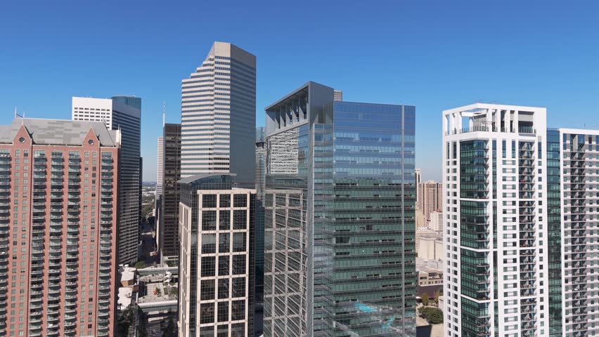 Houston Texas skyscrapers, daytime blue sky aerial drone establishing shot
