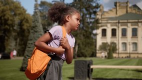 School education female student African American sad upset worried little girl schoolgirl pupil learner child kid go to primary class carrying heavy backpack frown difficult study walk outdoors city - Powered by Shutterstock - Get 15% off with code: PIKWIZARD15