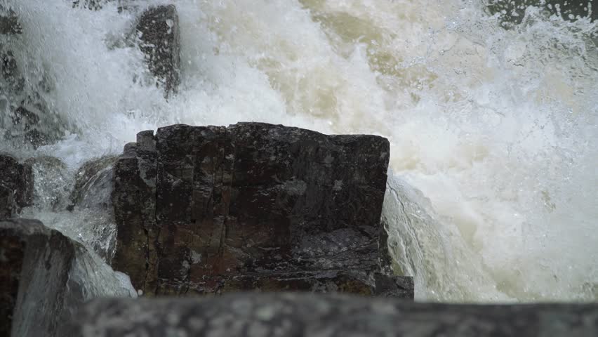 Majestic Norwegian Waterfall Cascading Over Rocky Terrain in a Lush Forest close-up
