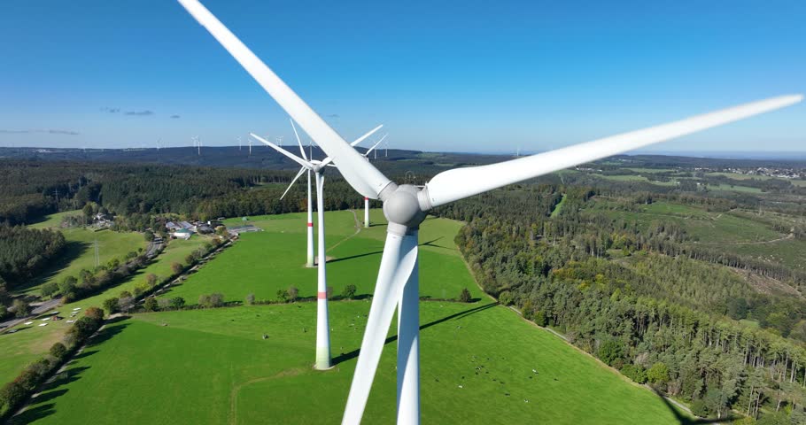 Wind turbines on the country side of Germany. SUstainable energy production. Aerial drone video.