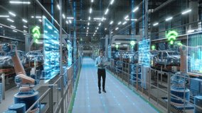 Technician Activates Smart Factory Floor. Advanced Manufacturing Visualization of Data Analysis, AI Production Optimization, Digital Information Lines in Autonomous Automotive Robot Arm Assembly Line - Powered by Shutterstock - Get 15% off with code: PIKWIZARD15