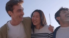 Diverse Gen z people having fun laughing standing embracing in line sunny day outdoors. Multiracial group of cheerful young friends smiling gathered together looking happy at each other in community - Powered by Shutterstock - Get 15% off with code: PIKWIZARD15