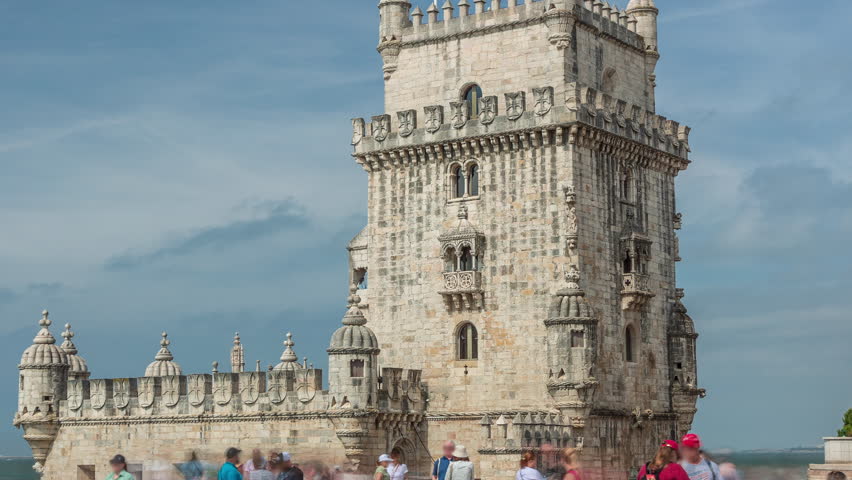 Torre de Belem or Belem Tower timelapse hyperlapse on the Rio Tejo in Belem district of the City of Lisbon in Portugal. Kiosk with fruits. People walking around. Cloudy sky