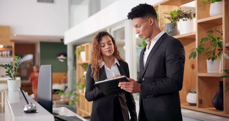 Hotel, reception and people with tablet in discussion for booking website, information or support. Man, woman and intern with tech at front desk for hospitality, online check in or help with training