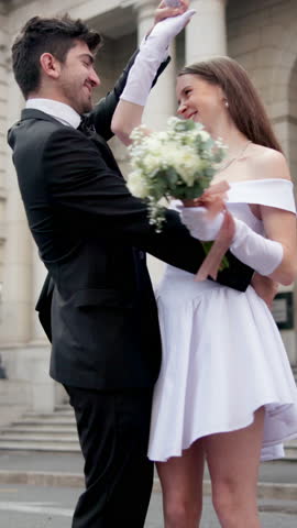 Marriage, dancing and couple with smile, city hall and civil wedding ceremony outdoor with love. Care, urban and happy people with spinning, flowers and embrace with commitment and loyalty together