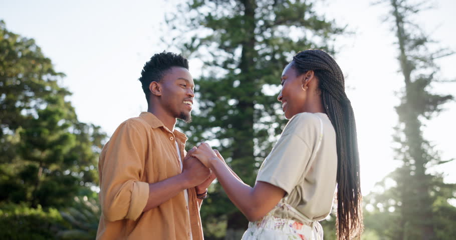 Outdoor, black couple and happy with holding hands for fun, date or bonding as lovers in Kenya. Park, people and smile in relationship as soulmate in love, care and trust with break to relax or chill