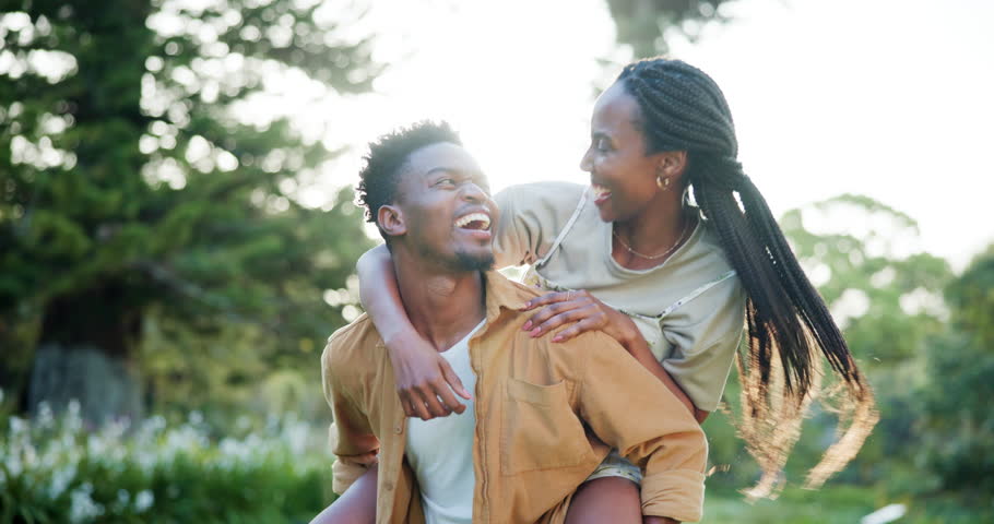 Outdoor, black couple and happy with piggyback for fun, date or bonding as lovers in Kenya. Park, people and smile in relationship as soulmate in love, care and trust with break to relax and chill