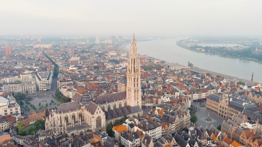 Antwerp, Belgium. Spire with the clock of the Cathedral of Our Lady (Antwerp). Historical center of Antwerp. City is located on river Scheldt (Escaut). Summer morning. Stable, Aerial View