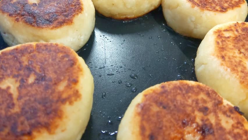 Golden Brown Syrniki Pancakes on Pan Traditional Slavic Breakfast Delight