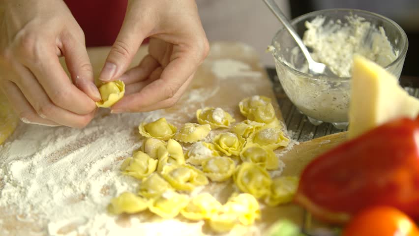 Homemade Fresh Pasta On Dinner. Italian Food Cooking. Meal For Lunch Or Dinner. Homemade italian 
Ravioli pasta with meat and cheese.  Ravioli in Tomato Sauce. Cooking Traditional italian Pasta Dish