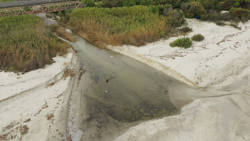 Stream River Flowing Polluted Water Into The Ocean Aerial View